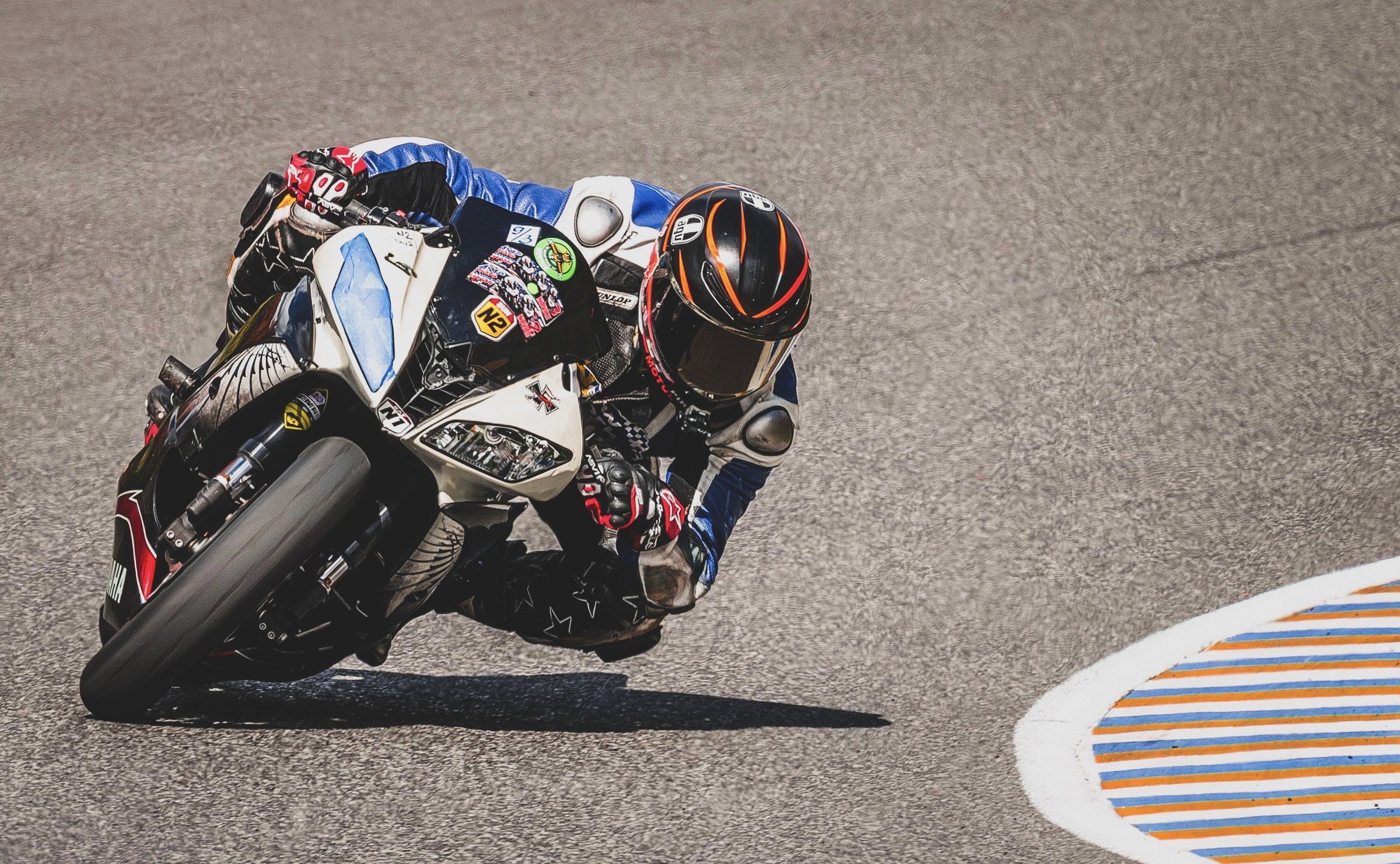 Rider on a white Yamaha leaned hard toward the curbing