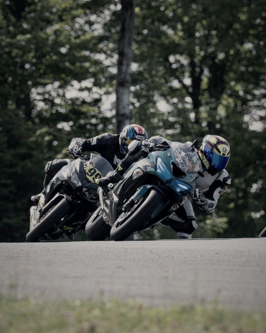Three riders stacked up through a corner at NY Raceport